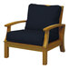 A Three Birds Casual Monterey wooden arm chair with black cushions.