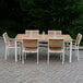 Three Birds Casual SoHo Stacking Side Chair with White Frame on a table and chairs on a brick patio