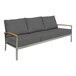 A grey couch with wooden armrests.