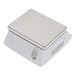 A white square Domino's portion scale with a metal surface.