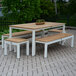 A white and wood Three Birds Casual SoHo backless bench on a brick patio table.