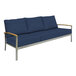 A navy Three Birds Casual Avanti outdoor sofa with blue cushions.