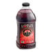 A bottle of Lotus Plant Power Red Lotus 5:1 energy concentrate with a red label filled with red liquid.