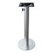 A silver pedestal with a black top and a hole for an umbrella.