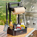 A Mr. Bar-B-Q adjustable caddy on a counter with condiments and a barbecue grill.