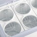 An Avantco white ice cream dipping cabinet with four containers of ice cream inside.