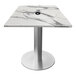 A white marble square table with a brushed aluminum base.