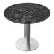 A round black marble table top with a metal base.