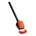A black and orange brush with a black handle and bristles.