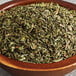 A bowl of Regal dried mint leaves on a table.