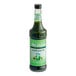 A bottle of Monin Matcha Green Tea Concentrate with green liquid inside.