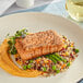 A plate with Oshi vegan salmon and vegetables on a table.