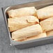 A metal tray filled with Tucson Foods Green Chile and Pork Tamales.