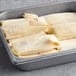 A white tray filled with Tucson Foods Green Chile and Cheese Tamales.