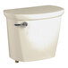 An American Standard Cadet PRO bone vitreous china toilet tank with lid and a silver handle.