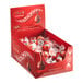 A red box of Lindt Lindor milk chocolate truffles.