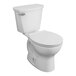 An American Standard white toilet with a lid down.