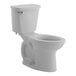 An American Standard white floor-mount chair height toilet with a silver handle and lid.