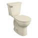 An American Standard Cadet PRO Bone Vitreous China toilet with the seat down.