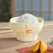 A round melamine rice bowl filled with rice and a fortune cookie.