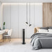 A white bedroom with a VisionAir black tower fan.