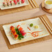 A rectangular Acopa Brassia melamine plate with sushi on it.