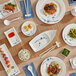 Acopa Biru melamine plates on a table with bowls of green food and rice.