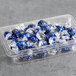 A plastic container of blue and white Lindt Lindor Dark Chocolate Truffles with white and yellow designs on the wrappers.