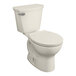 An American Standard linen round toilet with the seat down.