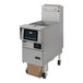 A Pitco stainless steel liquid propane floor fryer with a screen over it.