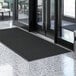 A black Lavex waffle entrance mat on a white surface.