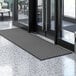 A black Lavex parquet entrance mat with a gray pattern on it.
