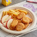 A plate of Dr. Praeger's Plant-Based Chickenless Nuggets and fries.
