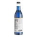 A close-up of a blue bottle of Capora Blue Raspberry flavoring syrup.