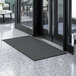 A black Lavex Water Absorbent Parquet entrance mat on the floor.