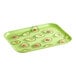 A green rectangular Cambro tray with an avocado design on a counter.