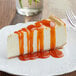 A slice of cheesecake with Capora pumpkin pie flavoring sauce on top.
