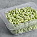 A plastic container of shelled edamame.