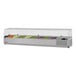 A Turbo Air stainless steel refrigerated countertop salad prep table with clear hood holding containers of vegetables.