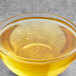 A bowl of Malt Products Organic Agave Syrup with bubbles.