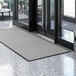 A large gray Lavex waffle entrance mat on a floor.