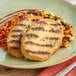 A white plate with Dr. Praeger's Plant-Based Vegan Chickenless Breasts, rice, and vegetables.