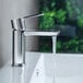 A Delta Modern Series chrome deck-mount faucet with running water.