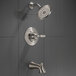 The stainless steel Delta Woodhurst bath and shower faucet with round shower head and handle.