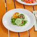 A World Centric ZeroWare reusable white plate with salad on it.