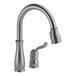 A Delta Leland kitchen faucet with pull-down sprayer and gooseneck spout.