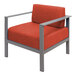 A BFM Seating Belmar armchair with a gray metal frame and orange Sunbrella cushion.