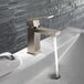 A silver Delta Modern bathroom faucet running water.