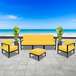 A BFM Seating Belmar yellow cushion on a black metal outdoor sofa.