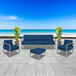 A white BFM Seating outdoor sofa with blue cushions.